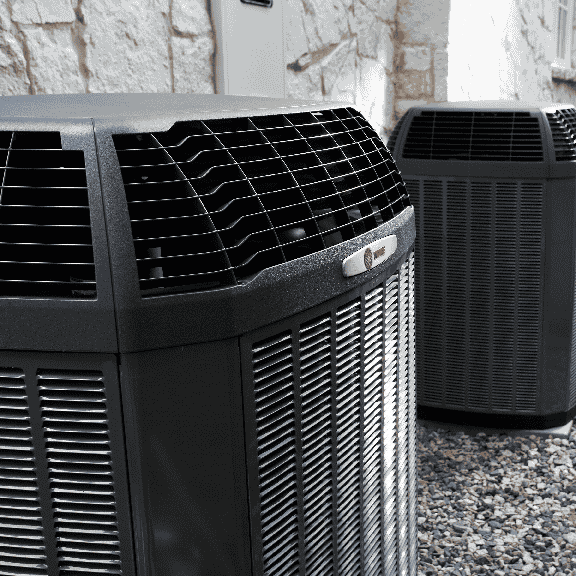 Two Trane HVAC units installed outdoors, maintained and serviced by Mann Plumbing & Heating.